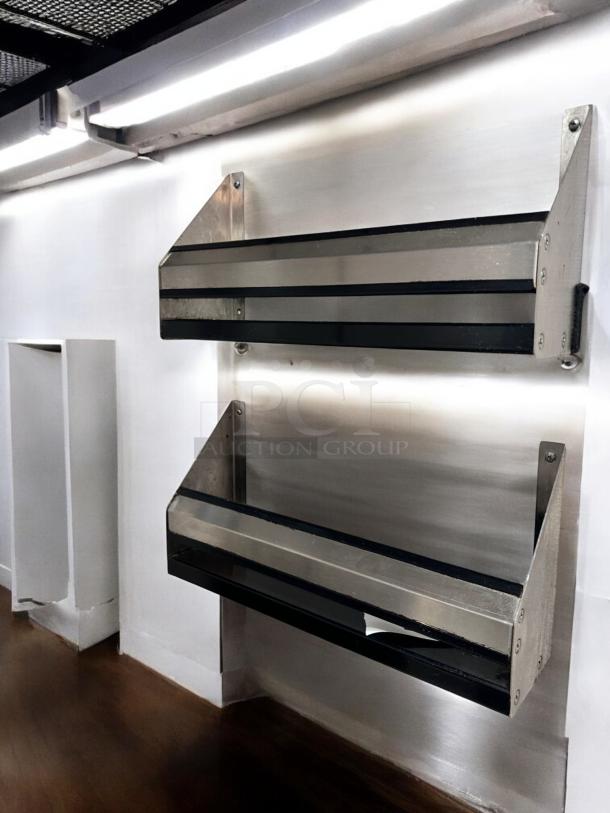 Two stainless steel wall-mounted organizer racks, 19" wide, with black edge trim. In superb condition, fully tested.