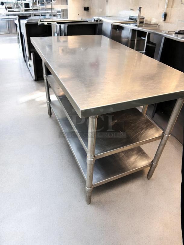 Heavy-duty stainless steel prep table with two undershelves, outstanding condition, fully tested and working.