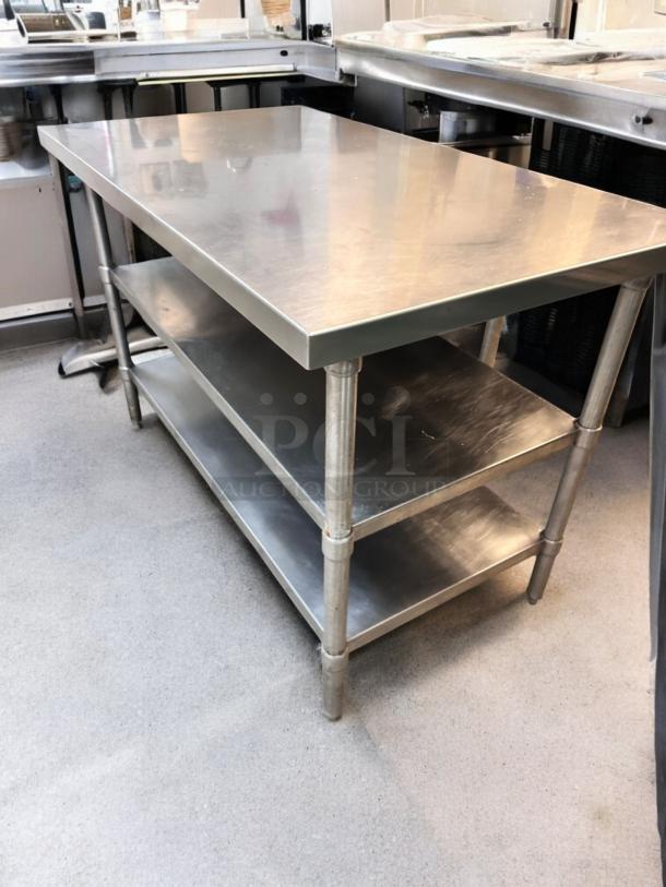 Heavy-duty stainless steel prep table with two undershelves, in outstanding condition. Fully tested and working.