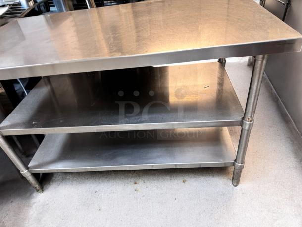 Heavy-duty stainless steel prep table with two undershelves, in outstanding condition, fully tested and working.