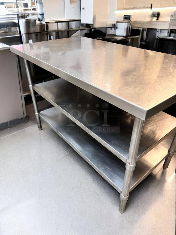 Heavy-duty stainless steel prep table with two undershelves, outstanding condition, fully tested and functional.