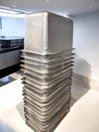 Stack of used commercial aluminum loaf pans in superb condition. Includes multiple pans, ready for service. Model: Commercial Standard.