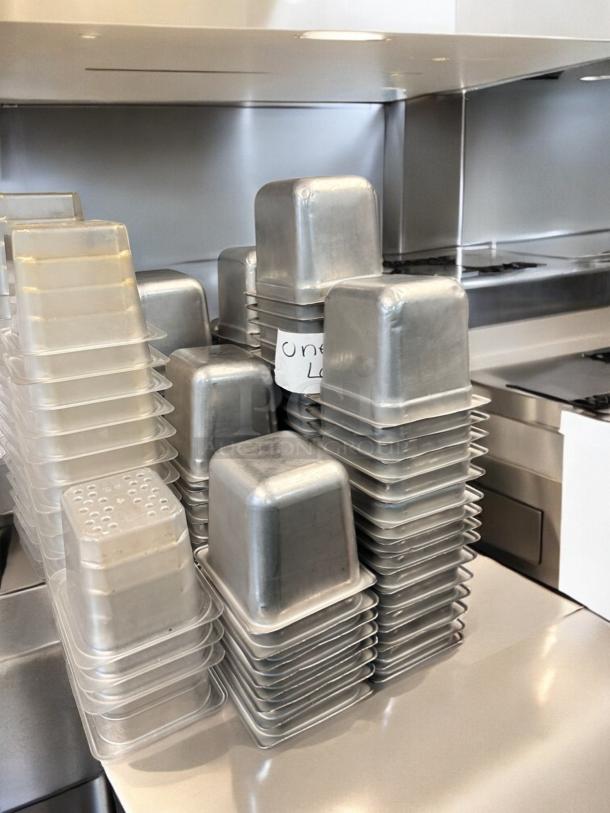 Used commercial aluminum loaf pan set in superb condition; stack of multiple units labeled "One Lot," ready for service.
