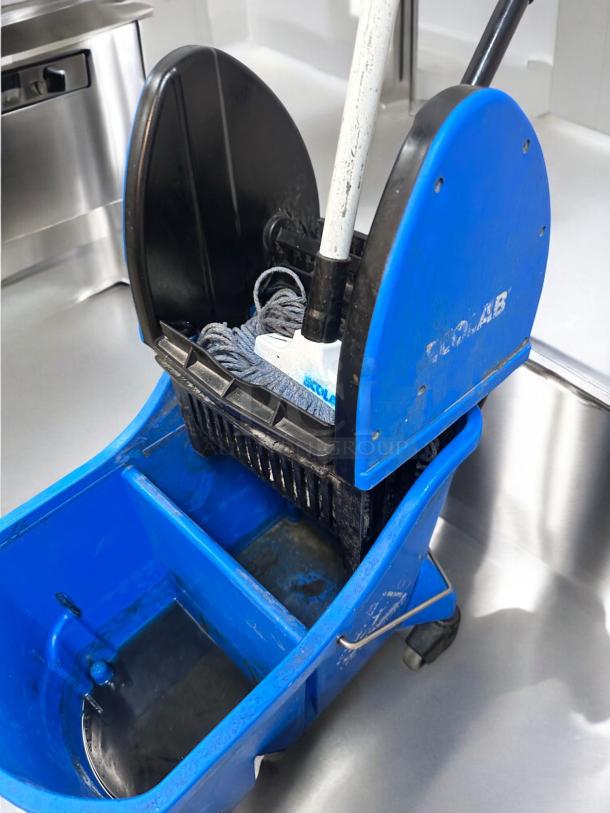 Ecolab dual-compartment mop bucket with wringer in great condition; ideal for commercial cleaning, fully tested.