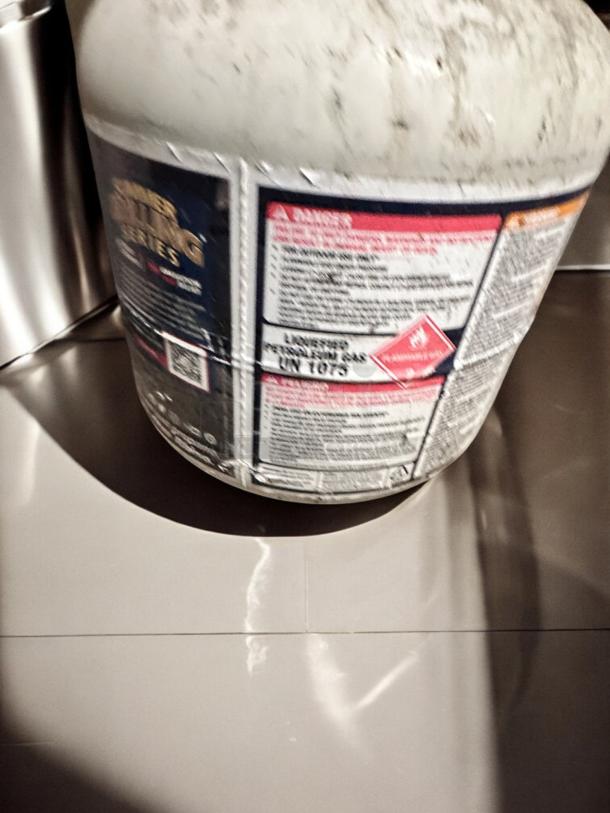 Blue Rhino 20 lb propane tank, empty, standard valve, outstanding condition, labels with safety warnings visible.