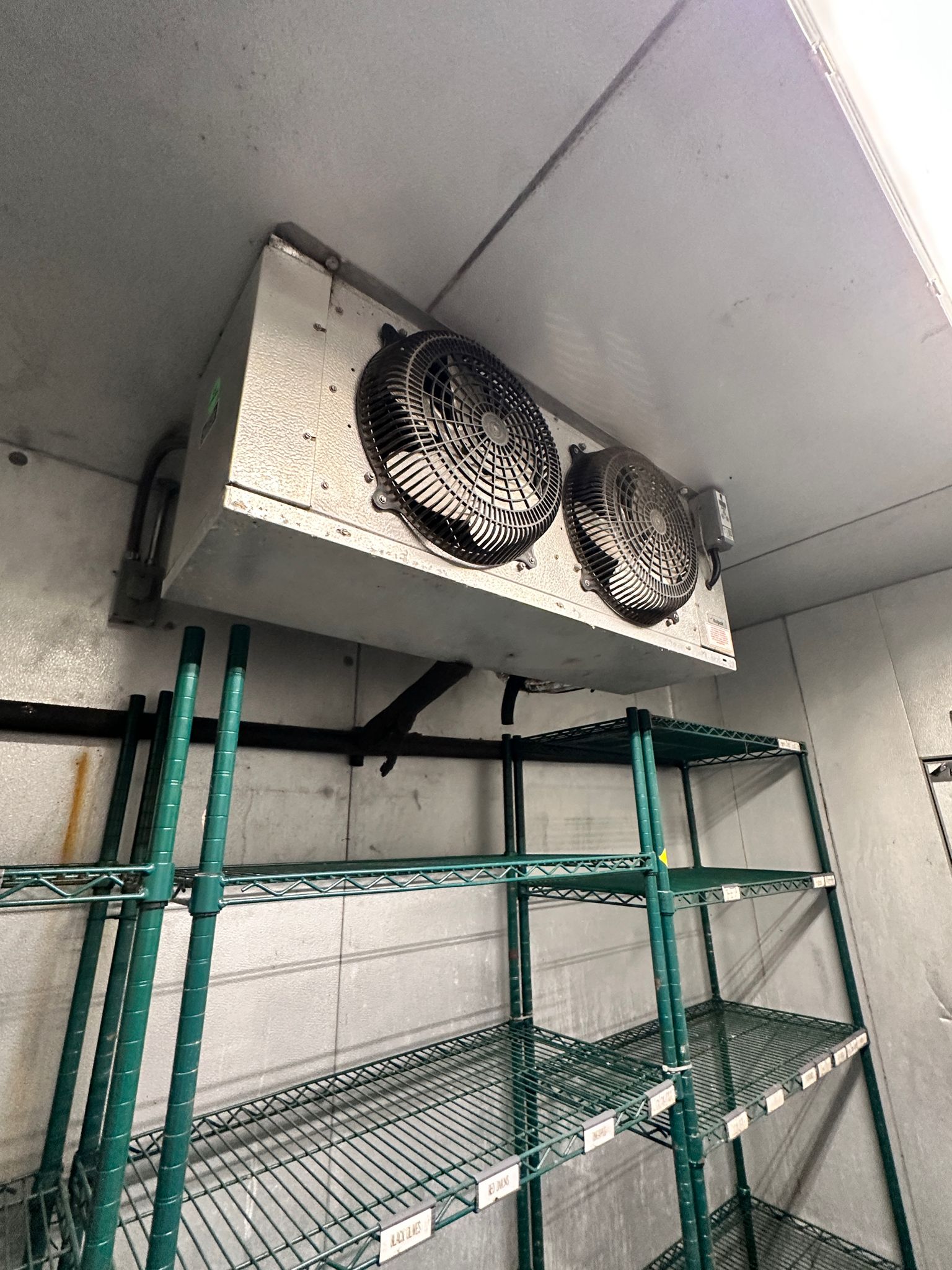 Walk-in cooler evaporator unit hanging inside box