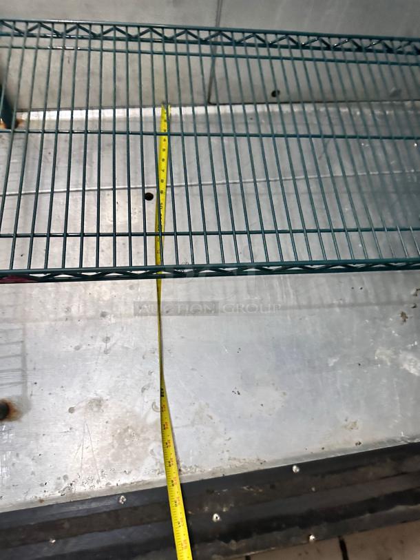 Used Kolpak Walk-In Cooler/Freezer shelf view. Model 4010130519DR25. Outstanding condition, 12'6" x 9'0" x 8'4". Tape measure shown.