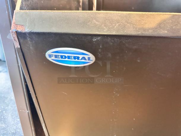 A metal cabinet with a "Federal" logo on the side. Brown finish with some visible scuffs and wear.
