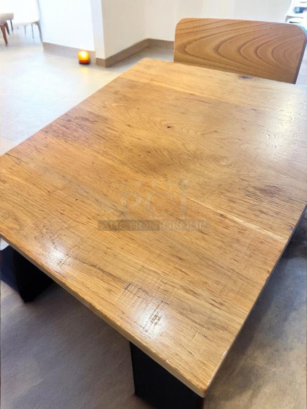 Solid wood café table, 27"x24", excellent condition. Commercial grade with steel base. Set of 7 available.