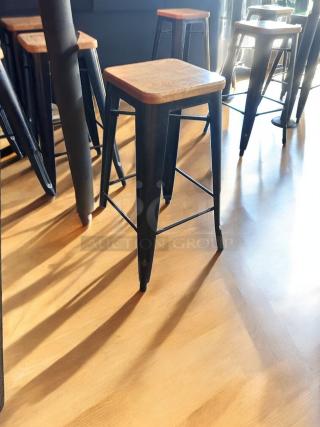 Set of 6 industrial bar-height stools with solid wood seats, matte black metal frames; excellent condition, fully functional.