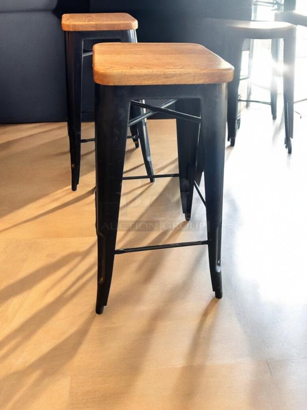 Industrial bar-height stools, qty 8, excellent condition. Solid wood seats, matte black metal frames. Fully functional.