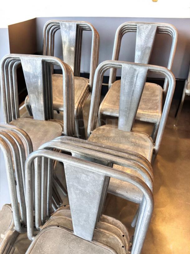 Stackable metal cafe chairs in impeccable condition, quantity 23. Ideal for commercial use.