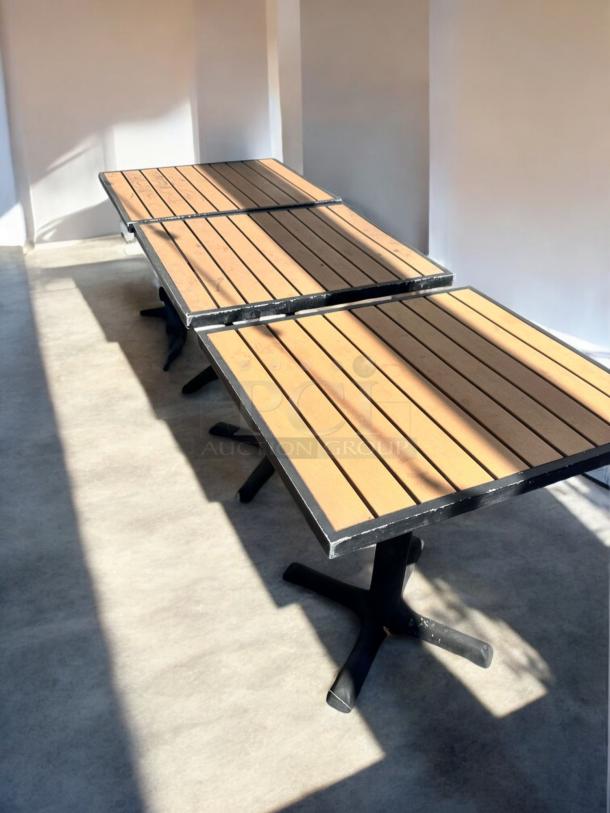 Like-new commercial outdoor patio tables with slatted tops and heavy-duty black bases, fully inspected and ready.