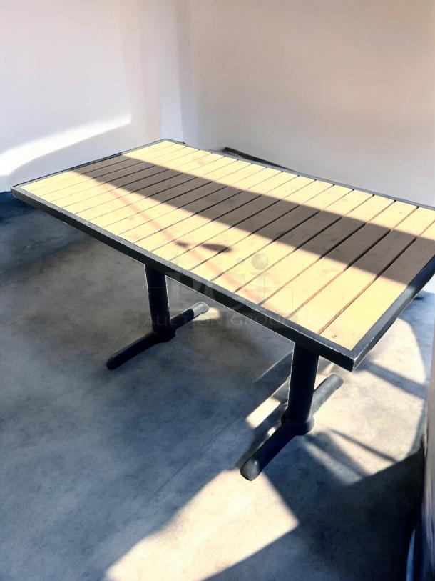 Like-new commercial outdoor patio table with slatted top, heavy-duty black base, fully inspected, ready to use.
