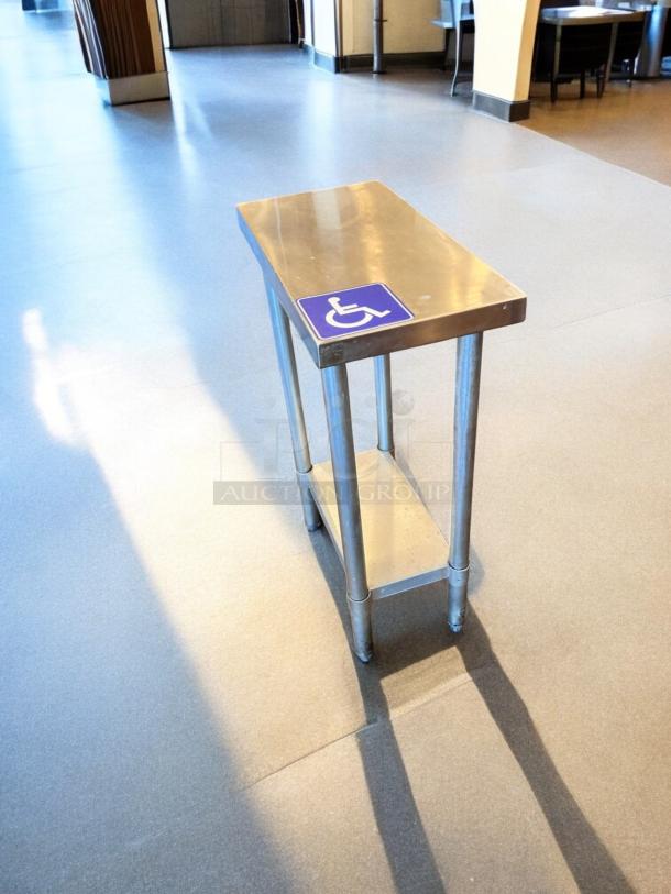 Compact stainless steel work table with undershelf, 24"x14", in great condition, ideal for commercial use.