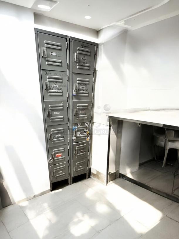 Metal employee locker cabinet with 12 compartments, very good condition, model 12-Door Vertical Locker, fully functional.