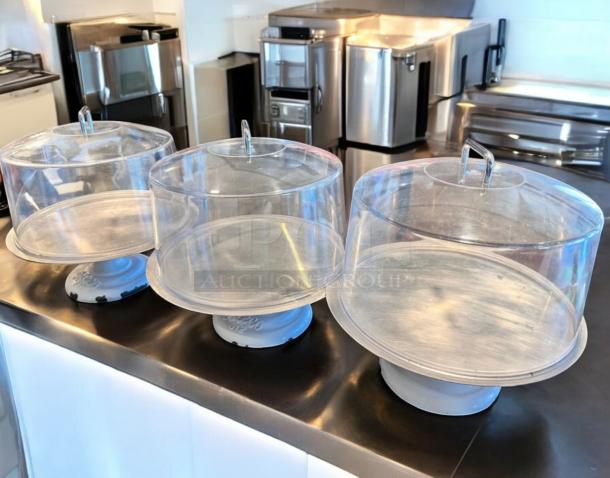 LIKE-NEW Greco 612 cake display stand with clear dome lid, white metal base. Tested, ready to use. Ideal for showcasing cakes.
