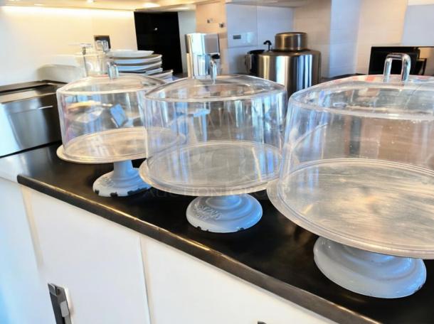 LIKE-NEW Greco 612 cake display stand, white metal base, clear dome lid, fully tested, ready to use.