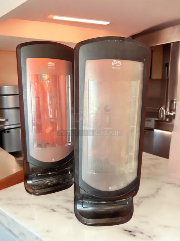 Tork Xpressnap tabletop napkin dispensers in black, very good condition, fully tested and functional.