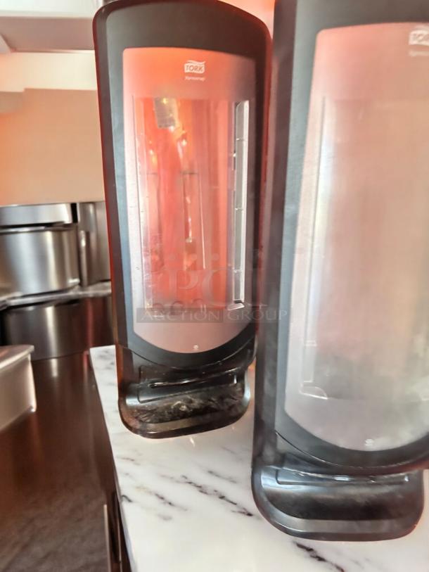 Tork Xpressnap tabletop napkin dispensers, black, very good condition, fully tested and functional, visible Tork branding.