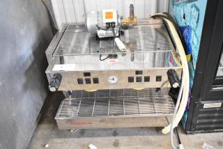 La Marzocco stainless steel 2-group commercial espresso machine with dual steam wands, showing control panel and pressure gauge.