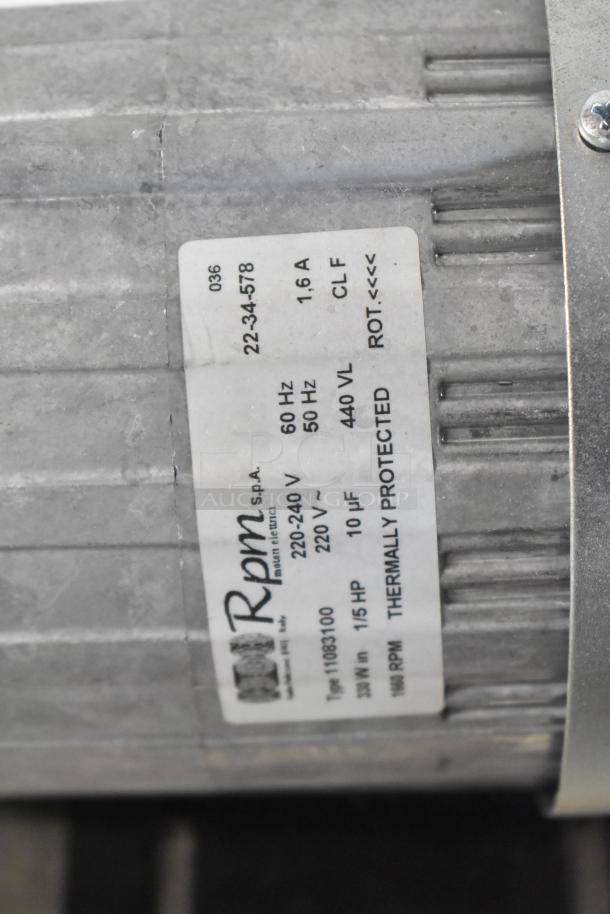 La Marzocco stainless steel espresso machine with 2 groups, 2 steam wands. Rpm label shows 220-240V, 1/5 HP motor specs.
