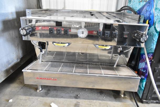 La Marzocco stainless steel 2-group espresso machine, commercial countertop model, with two steam wands and visible control knobs.