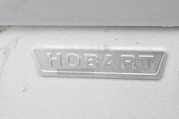 Hobart Legacy HL400 commercial mixer label, highlighting brand. Metal finish, slight wear visible, model identifier.