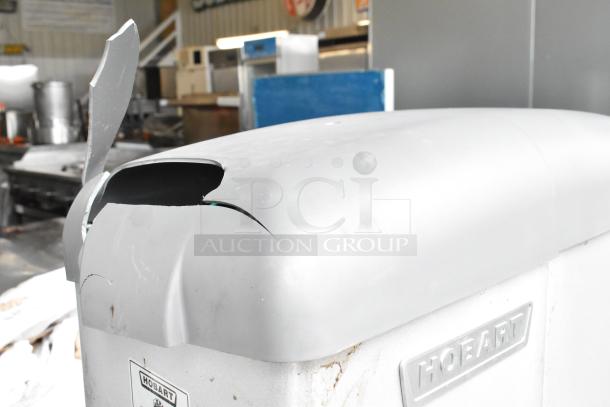 Hobart Legacy HL400 dough mixer with visible damage on upper casing, showing peeling paint. Includes branding plate.