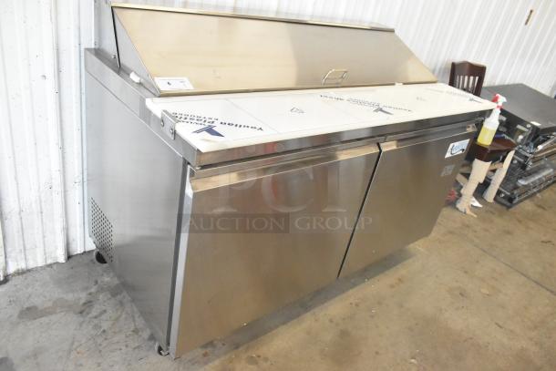 Avantco 178SSPT60 stainless steel sandwich salad prep table, brand new with minor scratches, features two doors and commercial casters.