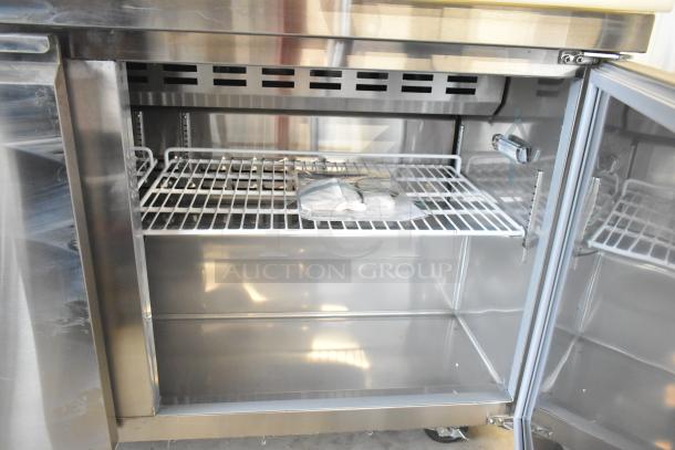 Brand new Avantco 178SSPT60 stainless steel sandwich prep table. Scratch and dent. Includes wire shelves, on casters. 115V, 1 phase.