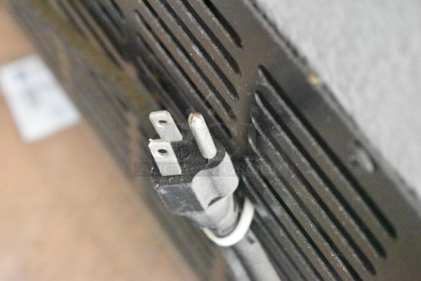 Plug and back panel of Avantco 178SSPT60 stainless steel commercial prep table, shown with a 115V power cord.