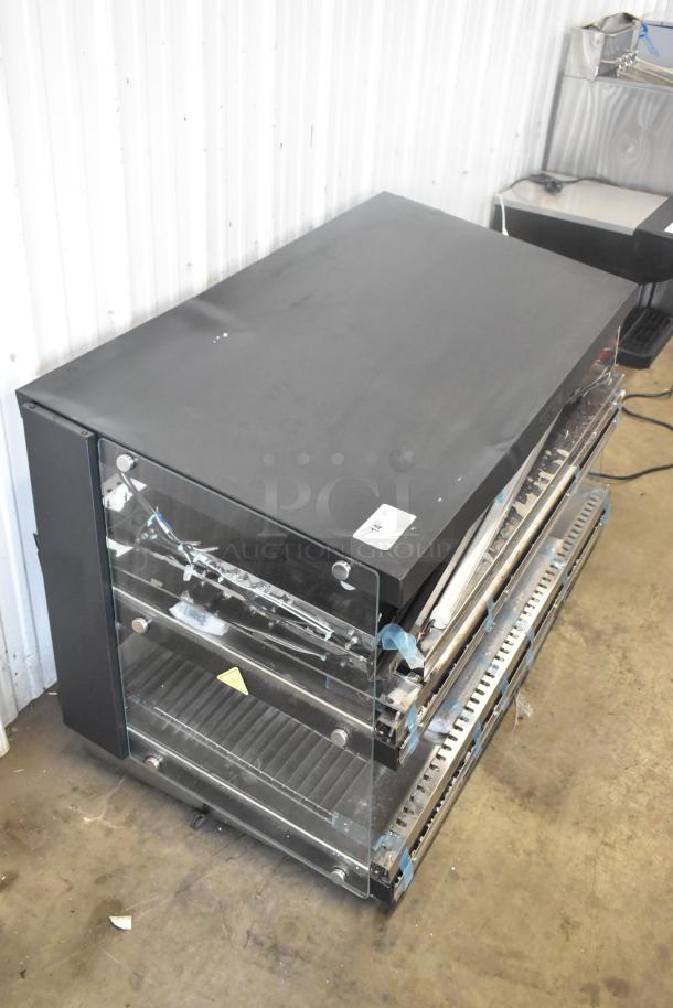 Brand new ServIt 423OAM138D 48" slanted 2-shelf heated display merchandiser; minor scratches and dents visible.