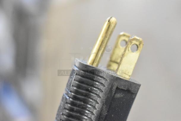 Close-up of a power plug for a Pro-Cut KG-12-SS stainless steel meat grinder, showing prongs and grip details.