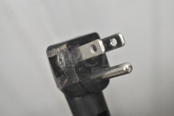 Close-up image of a black and silver electrical plug from the 2023 Manitowoc UCP0050A-161 ice machine.