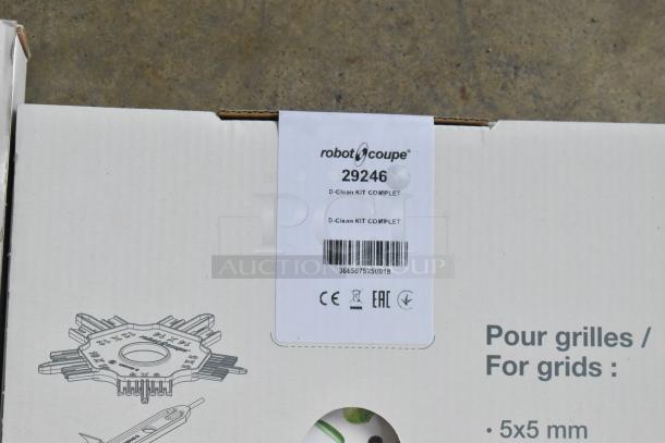 Brand new Robot Coupe R 702 8 Qt. food processor with 28064W slicing disc, 29246 dice cleaning kit, 28058 shredding disc. Label shows model and kit details.