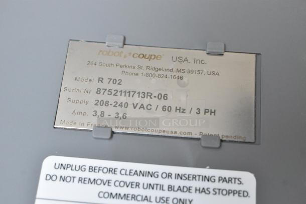 Robot Coupe R 702 data plate, showing model, serial number, voltage (208-240 VAC), and usage instructions.