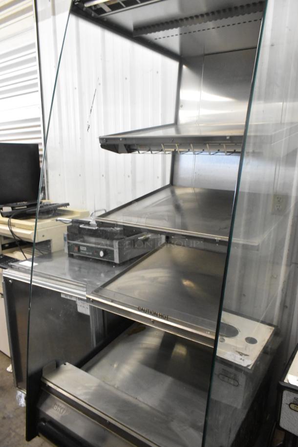 BKI HSS2-4T 3-tier heated merchandiser with glass sides on casters. 208V, 1 phase. Metal finish, "Caution Hot" label visible.