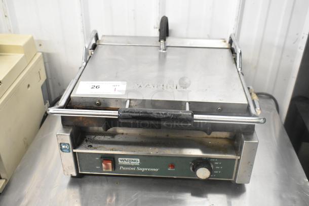 Waring WPG250 stainless steel commercial panini press, visible wear, 120V, 1 phase, featuring temperature dial and on/off switch.