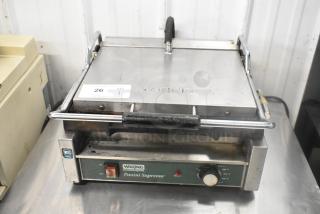 Waring WPG250 stainless steel commercial panini press, visible wear, 120V, 1 phase, featuring temperature dial and on/off switch.