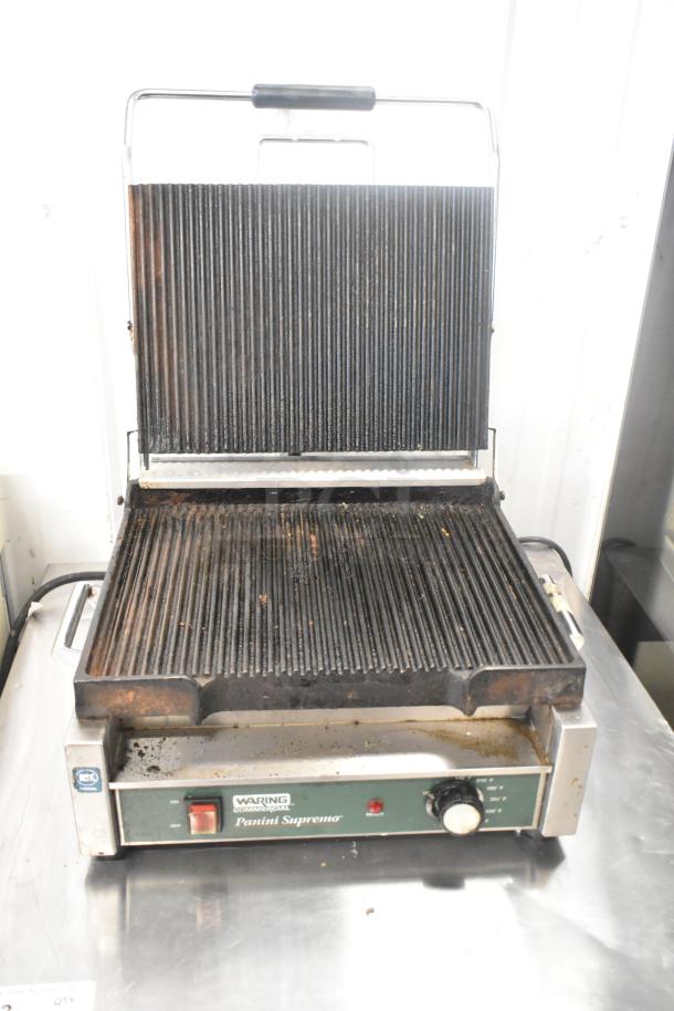Waring WPG250 stainless steel commercial panini press with ribbed plates, 120 volts, 1 phase, used condition.