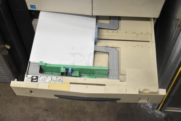 Kyocera AGK3 floor-style copier printer scanner, open paper tray view. Cream color, good condition, with instructional labels.
