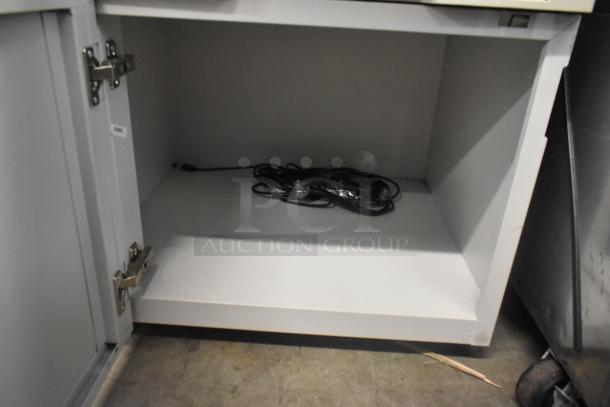 Kyocera AGK3 copier printer scanner; floor style, model AGK3. Open cabinet below with coiled cables.