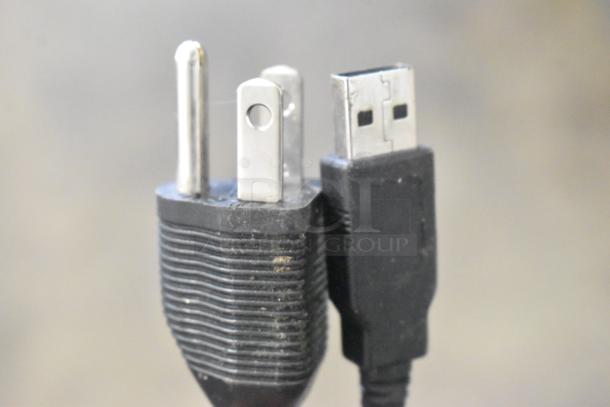 Alt text: Close-up of a USB and power plug.