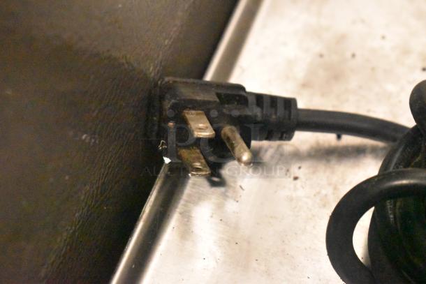 Power cord of Midea MRC04M3AWW Chest Freezer, showing standard 115V plug, suitable for typical outlets.
