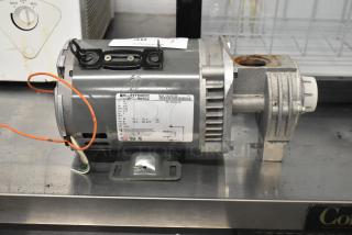 Bluffton 1101007735 motor, 115 volts, 1 phase, with visible label and mounting base, in used condition.