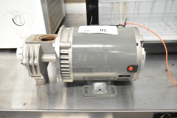 Bluffton 1101007735 motor, 115 volts, 1 phase, shown in used condition with visible mounting base and wiring.
