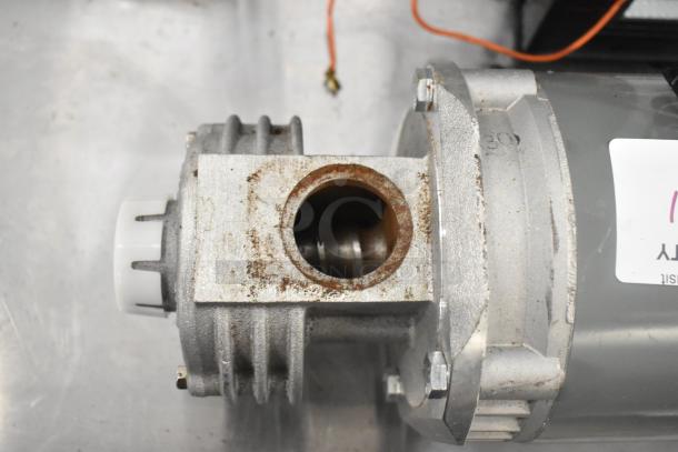 Bluffton 1101007735 Motor, 115V, 1 Phase, visible wear, metal casing, label attached.