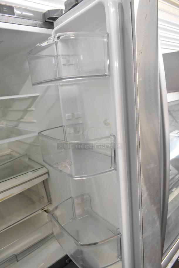 LG LFCS22520S stainless steel fridge with freezer drawer, 115 volts, 1 phase; interior door shelves shown.