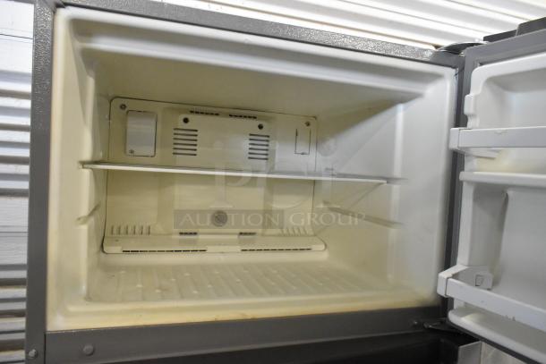2016 Whirlpool WRT518SZFM00 stainless steel freezer interior, featuring a single shelf and adjustable thermostat.